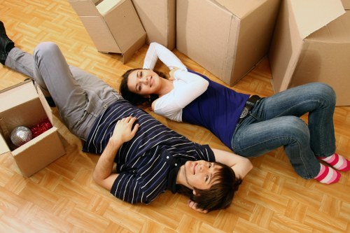 Removal team handling furniture in a Dartmouthpark flat